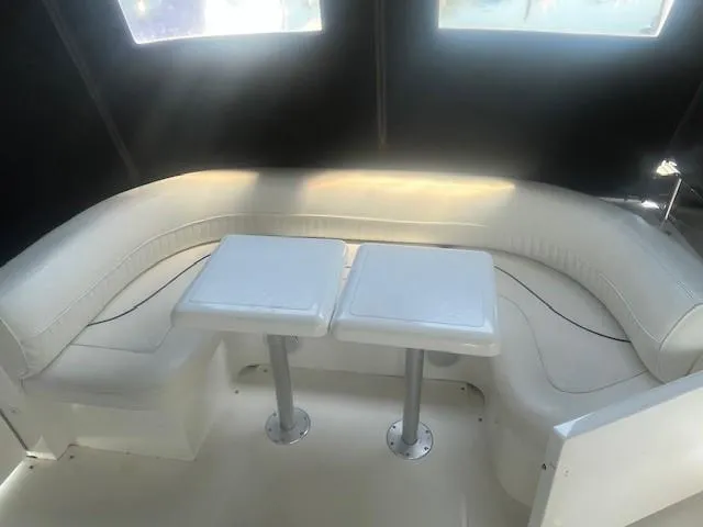  Yacht Photos Pics 2000 Cruisers Yachts 4450 Express Motoryacht interior with white seating and dual tables.