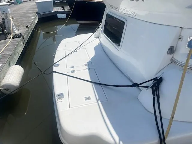  Yacht Photos Pics 2000 Cruisers Yachts 4450 Express Motoryacht docked at marina.