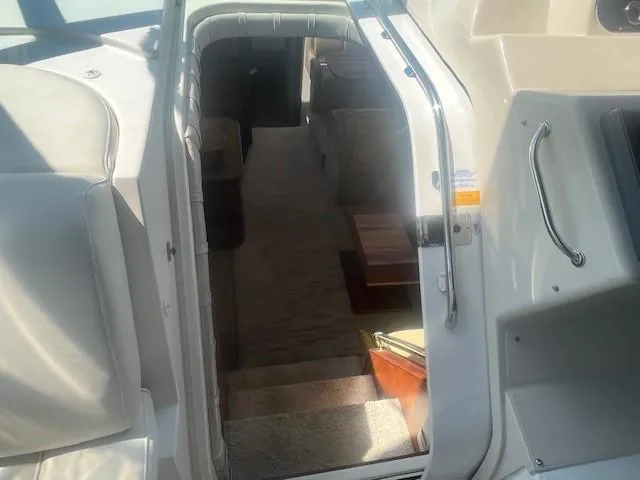  Yacht Photos Pics 2000 Cruisers Yachts 4450 Express Motoryacht interior view with stairs and seating area.