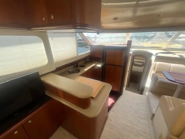  Yacht Photos Pics Interior of 2000 Cruisers Yachts 4450 Express Motoryacht with kitchen and seating area.