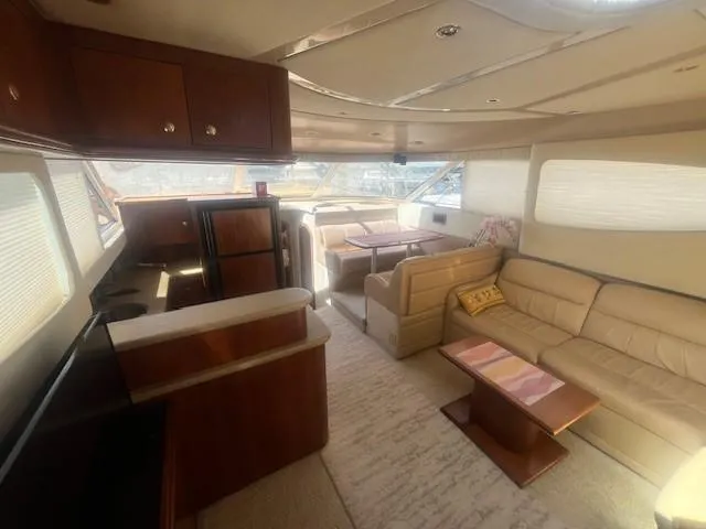  Yacht Photos Pics Luxurious interior of 2000 Cruisers Yachts 4450 Express Motoryacht with elegant seating and kitchen area.
