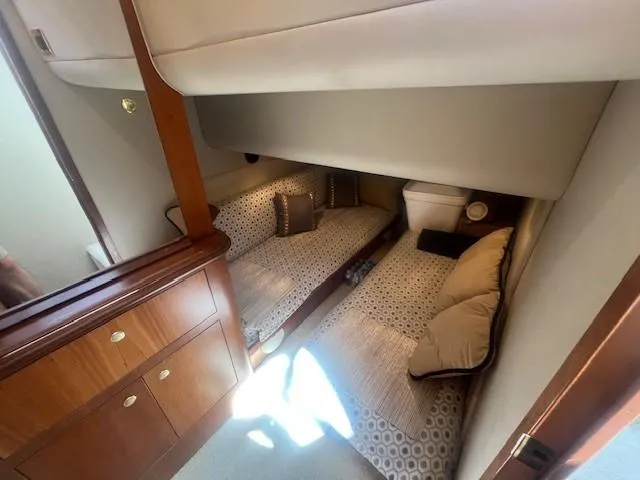  Yacht Photos Pics Interior cabin of 2000 Cruisers Yachts 4450 Express Motoryacht with twin beds and wooden cabinetry.