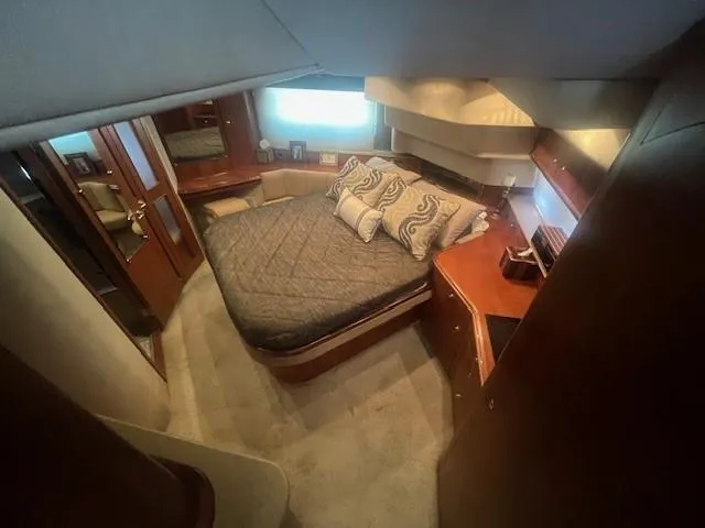  Yacht Photos Pics Luxurious bedroom in 2000 Cruisers Yachts 4450 Express Motoryacht with elegant wood finishes.
