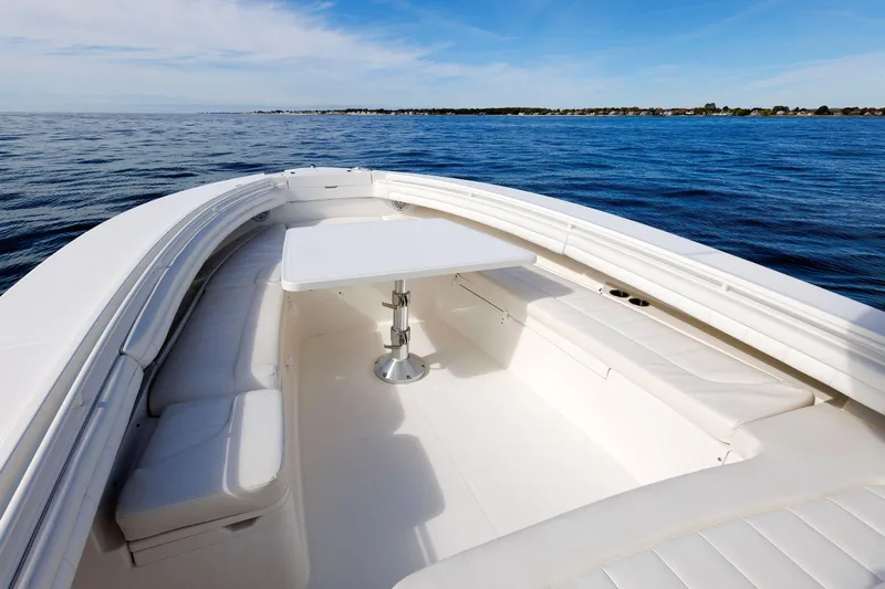 34 Ss Yacht Photos Pics 2018 Regulator 34SS boat with spacious seating and table on calm ocean waters.