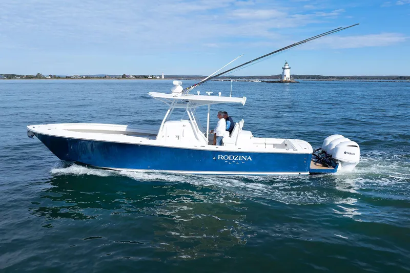 34 Ss Yacht Photos Pics 2018 Regulator 34SS boat cruising near a lighthouse on calm waters.