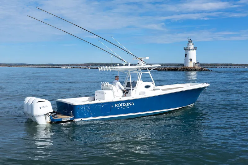 34 Ss Yacht Photos Pics 2018 Regulator 34SS boat on water near lighthouse, clear sky.