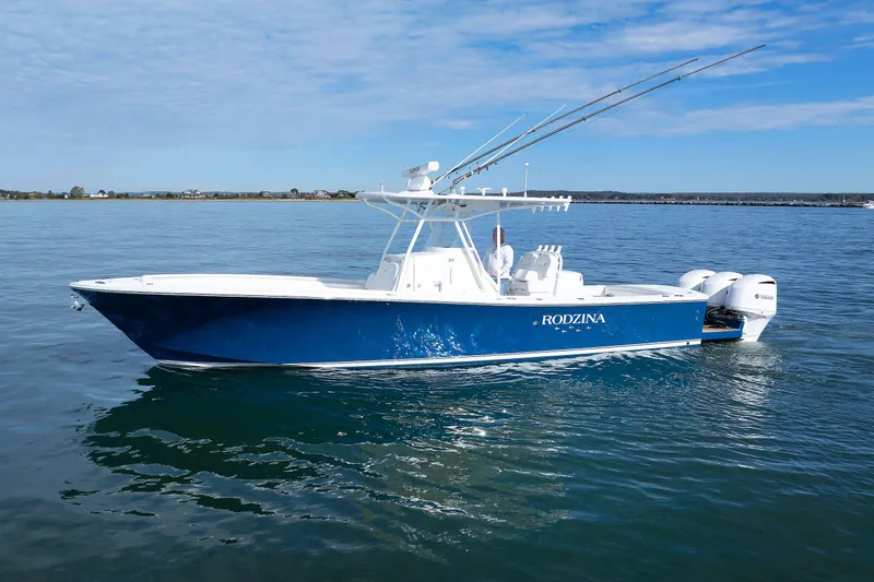 34 Ss Yacht Photos Pics 2018 Regulator 34SS boat on calm water, blue hull, twin Yamaha engines.