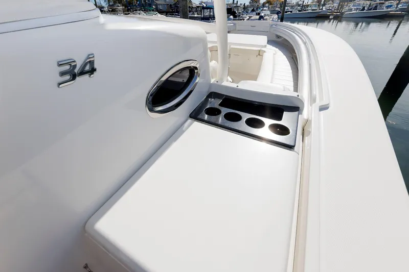 34 Ss Yacht Photos Pics 2018 Regulator 34SS boat with cup holders and sleek design at a marina.