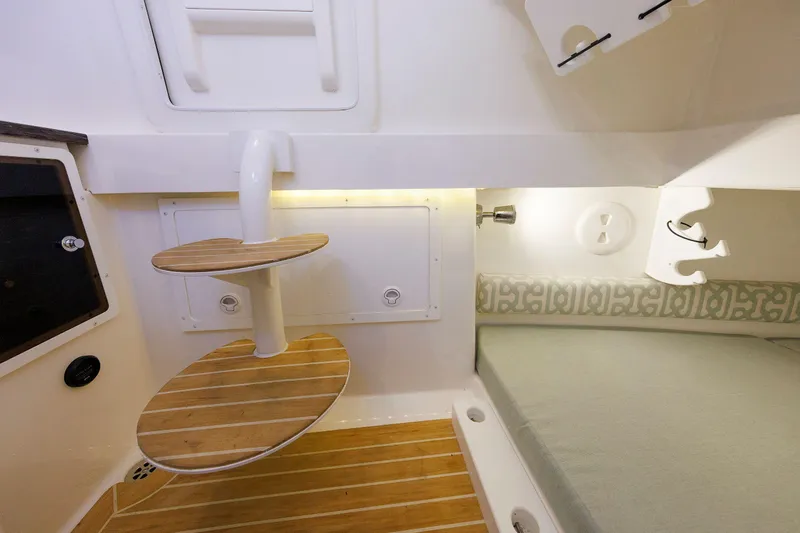 34 Ss Yacht Photos Pics 2018 Regulator 34SS cabin interior with wooden steps and cushioned seating area.