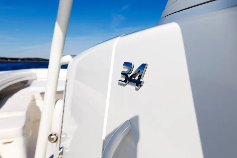 34 Ss Yacht Photos Pics 2018 Regulator 34SS boat detail with chrome emblem against blue sky.