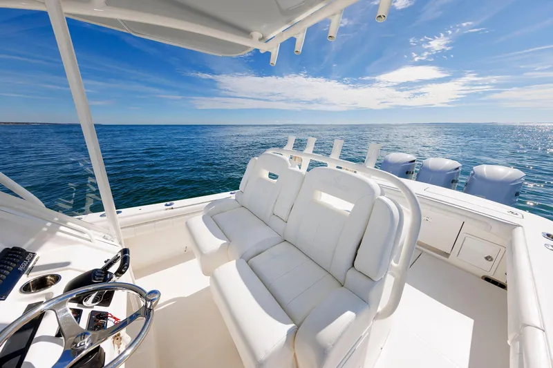 34 Ss Yacht Photos Pics 2018 Regulator 34SS boat interior with white seating, ocean view, and clear blue sky.