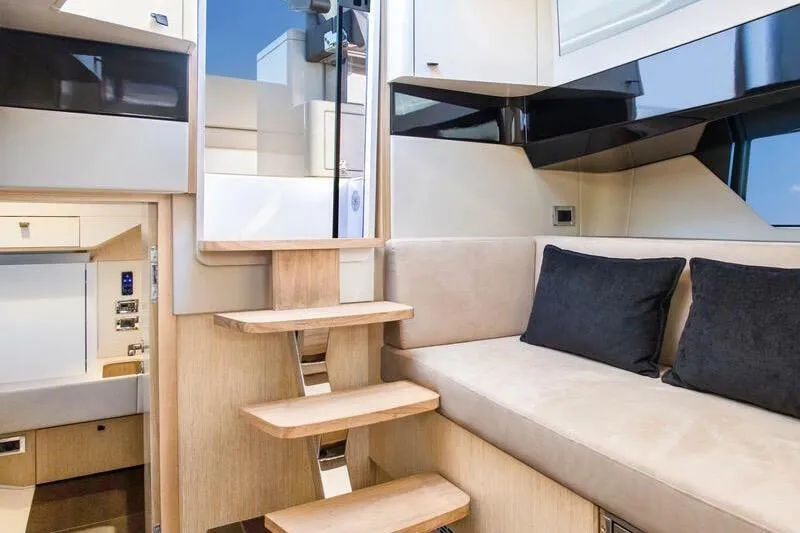 Fjord 41 Xl Yacht Photos Pics Interior of 2021 Fjord 41 XL yacht with modern seating and wooden steps.