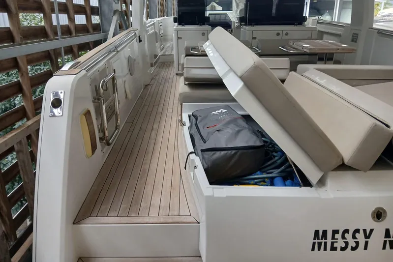 Fjord 41 Xl Yacht Photos Pics 2021 Fjord 41 XL yacht interior with open storage compartment and seating area.