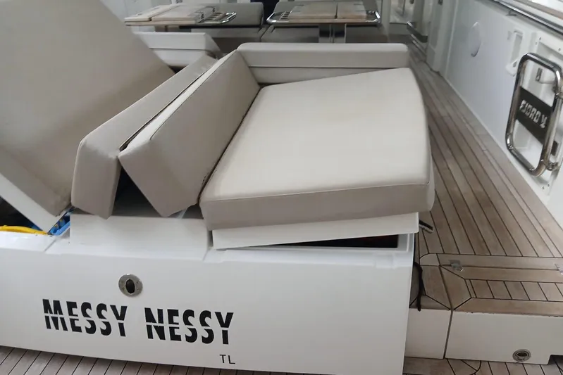Fjord 41 Xl Yacht Photos Pics Luxury seating on 2021 Fjord 41 XL yacht deck, featuring "Messy Nessy" branding.