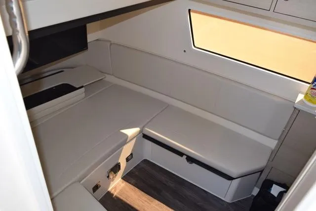 Way Out Yacht Photos Pics 2023 Scout 377 LXF cabin interior with seating and window.