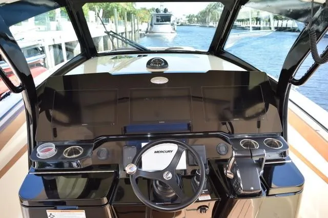 Way Out Yacht Photos Pics 2023 Scout 377 LXF boat helm with Mercury steering wheel and modern controls.