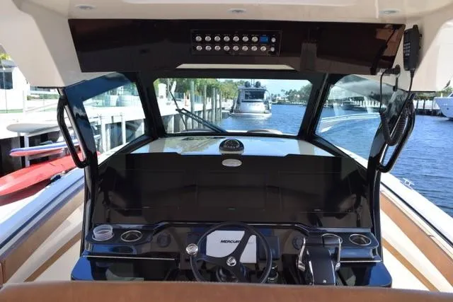 Way Out Yacht Photos Pics 2023 Scout 377 LXF boat helm with Mercury controls and waterfront view.