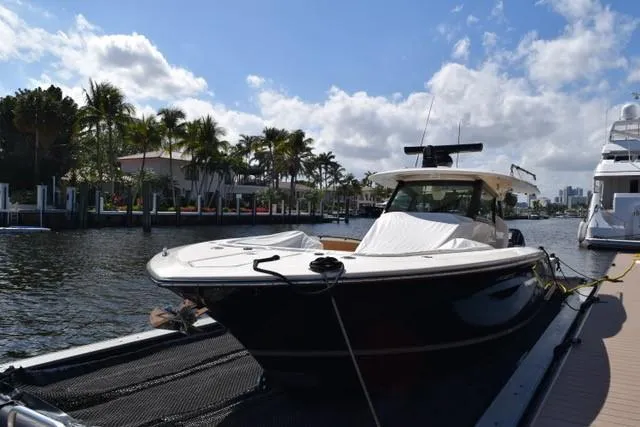 Way Out Yacht Photos Pics 2023 Scout 377 LXF boat docked by waterfront homes.