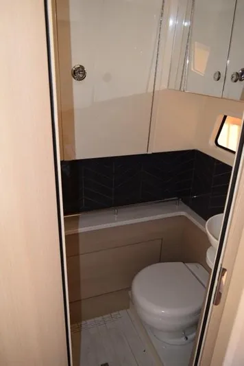 Way Out Yacht Photos Pics 2023 Scout 377 LXF boat bathroom with modern fixtures and compact design.