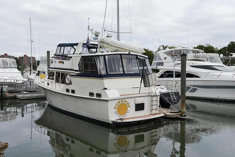 Sunshine Yacht Photos Pics 1986 Marine Trader Tradewinds 47 yacht docked in a marina.