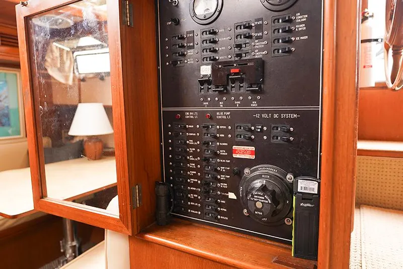 Sunshine Yacht Photos Pics Electrical panel inside a 1986 Marine Trader Tradewinds 47 yacht, showcasing switches and controls.