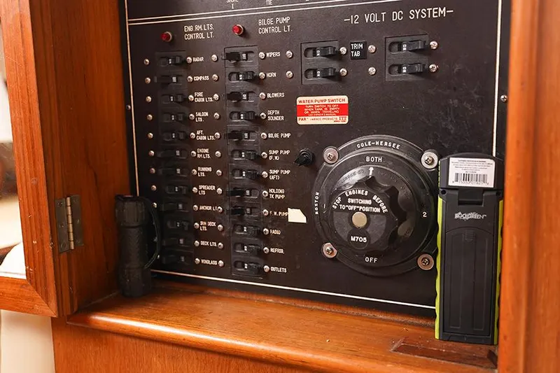 Sunshine Yacht Photos Pics Electrical panel of a 1986 Marine Trader Tradewinds 47 boat, featuring switches and controls.