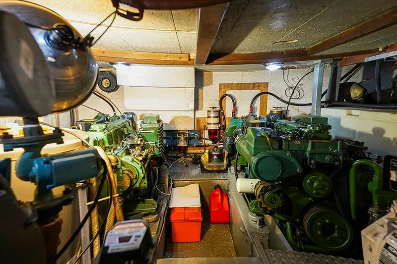 Sunshine Yacht Photos Pics Engine room of 1986 Marine Trader Tradewinds 47 yacht, featuring dual green engines and equipment.