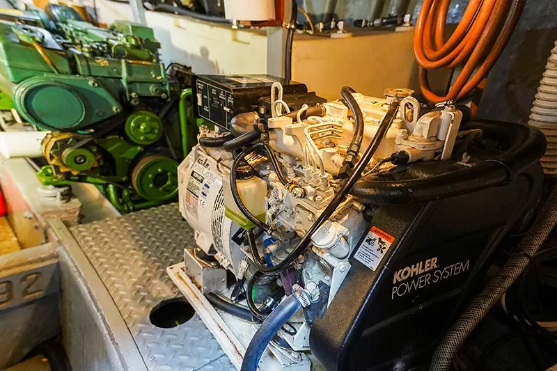 Sunshine Yacht Photos Pics Engine room of 1986 Marine Trader Tradewinds 47 with Kohler power system and green engine.