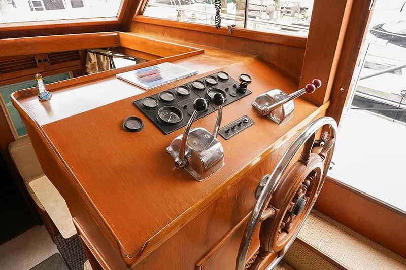 Sunshine Yacht Photos Pics 1986 Marine Trader Tradewinds 47 helm with wooden wheel and control panel.