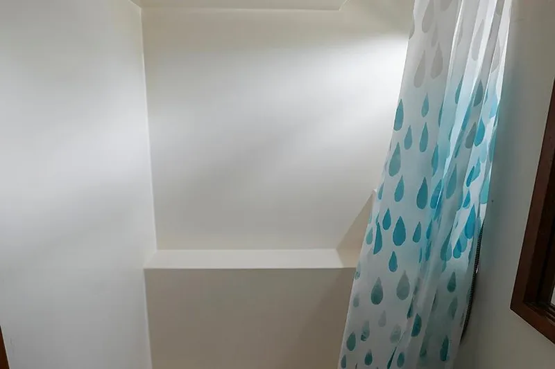 Sunshine Yacht Photos Pics Shower area with blue raindrop curtain on 1986 Marine Trader Tradewinds 47 yacht.