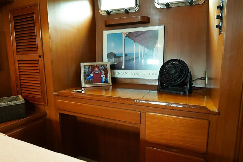Sunshine Yacht Photos Pics Cozy cabin interior of 1986 Marine Trader Tradewinds 47 with wooden desk and decor.