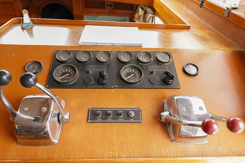 Sunshine Yacht Photos Pics Control panel of a 1986 Marine Trader Tradewinds 47 yacht with gauges and levers.