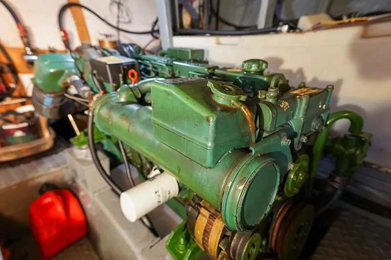 Sunshine Yacht Photos Pics Engine room of 1986 Marine Trader Tradewinds 47 yacht, showcasing a green marine engine.