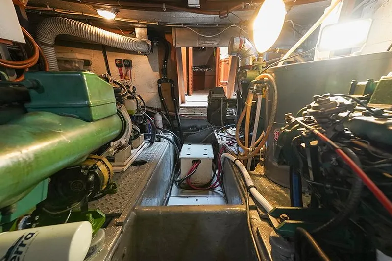Sunshine Yacht Photos Pics Engine room of 1986 Marine Trader Tradewinds 47 yacht, showcasing mechanical components and wiring.