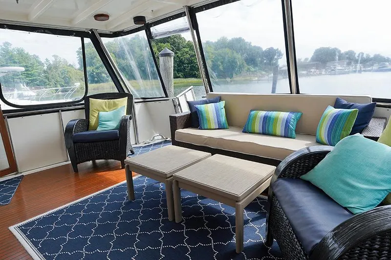 Sunshine Yacht Photos Pics Spacious 1986 Marine Trader Tradewinds 47 yacht interior with cozy seating and vibrant cushions.