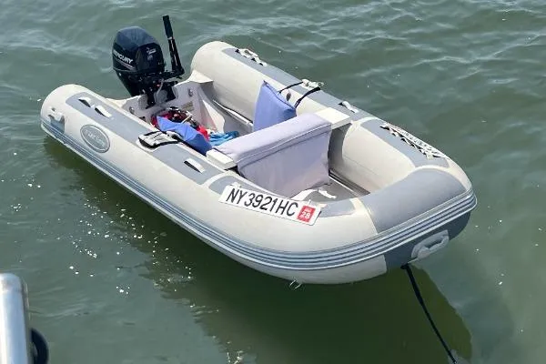 Sunshine Yacht Photos Pics Inflatable boat with outboard motor on water, registration NY3921HC, near Marine Trader Tradewinds 47.