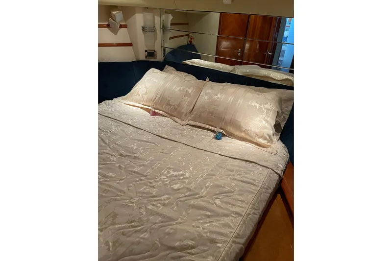 Offshore Flyer Yacht Photos Pics Luxurious bedroom interior of 2000 Azimut 46 Flybridge MY yacht with elegant bedding.