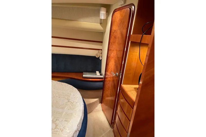 Offshore Flyer Yacht Photos Pics Luxurious interior of 2000 Azimut 46 Flybridge yacht with wood finishes and cozy seating.
