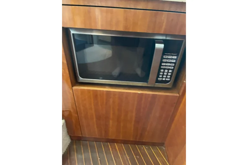 Offshore Flyer Yacht Photos Pics Microwave in wooden cabinet on 2000 Azimut 46 Flybridge yacht.
