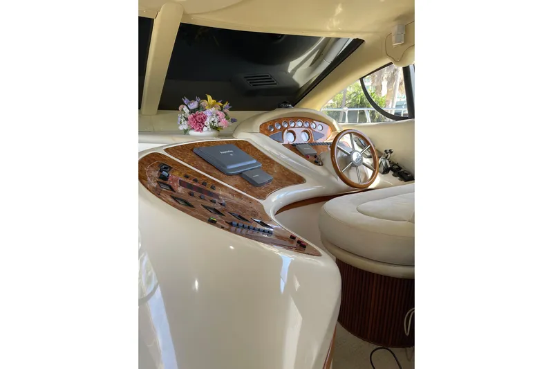 Offshore Flyer Yacht Photos Pics Luxurious helm of 2000 Azimut 46 Flybridge MY with wood accents and floral decor.