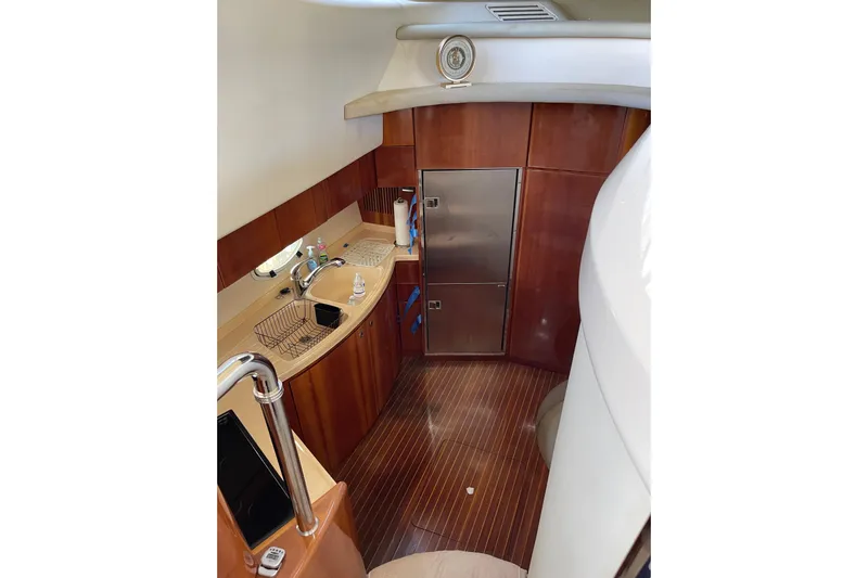Offshore Flyer Yacht Photos Pics Luxurious kitchen interior of 2000 Azimut 46 Flybridge MY yacht with wood finish.
