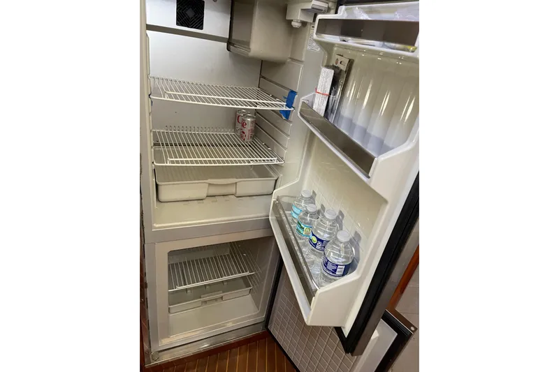 Offshore Flyer Yacht Photos Pics Open fridge on 2000 Azimut 46 Flybridge MY with drinks and empty shelves.