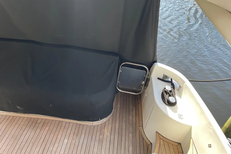 Offshore Flyer Yacht Photos Pics Azimut 46 Flybridge MY 2000 yacht deck with wooden flooring and water view.