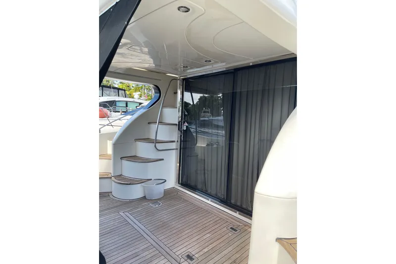 Offshore Flyer Yacht Photos Pics Azimut 46 Flybridge MY 2000 yacht interior with wooden stairs and sliding glass door.