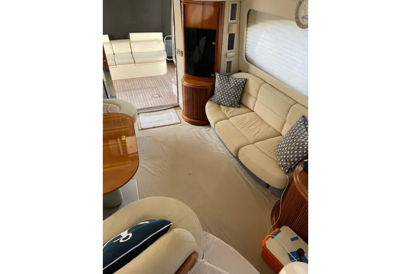 Offshore Flyer Yacht Photos Pics Luxurious interior of 2000 Azimut 46 Flybridge MY yacht with beige seating and wooden accents.