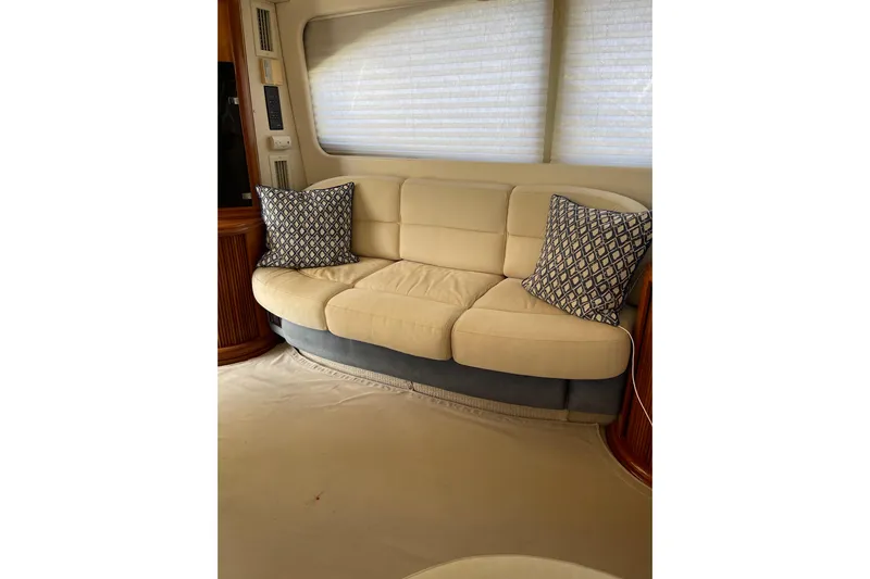Offshore Flyer Yacht Photos Pics Luxurious interior of 2000 Azimut 46 Flybridge MY with beige sofa and patterned cushions.