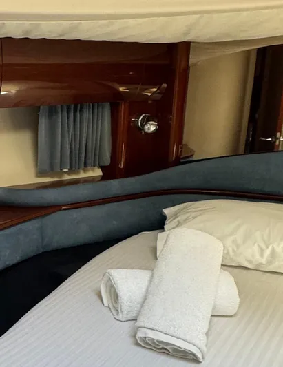  Yacht Photos Pics Luxurious cabin interior of 2004 Princess V65 yacht with plush bedding and towels.