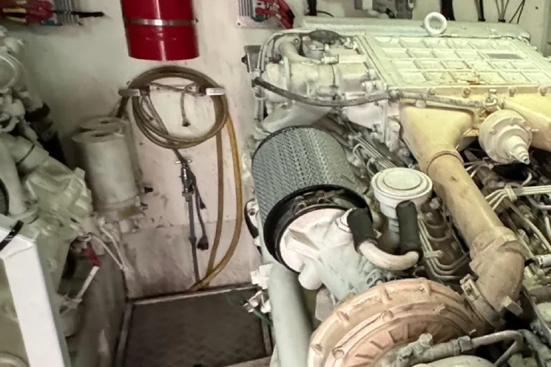  Yacht Photos Pics Engine room of a 2004 Princess V65 yacht, featuring mechanical components and fire safety equipment.