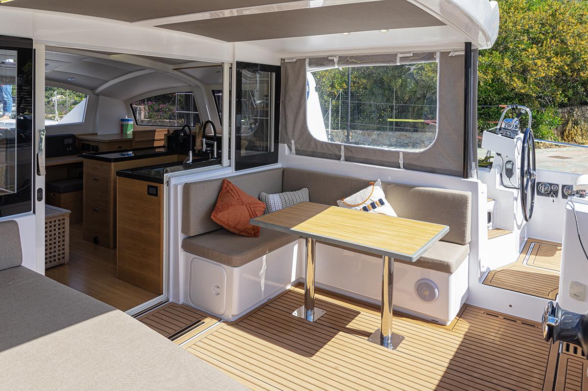 2025 Comar C-Cat 48 yacht interior with modern seating and dining area.