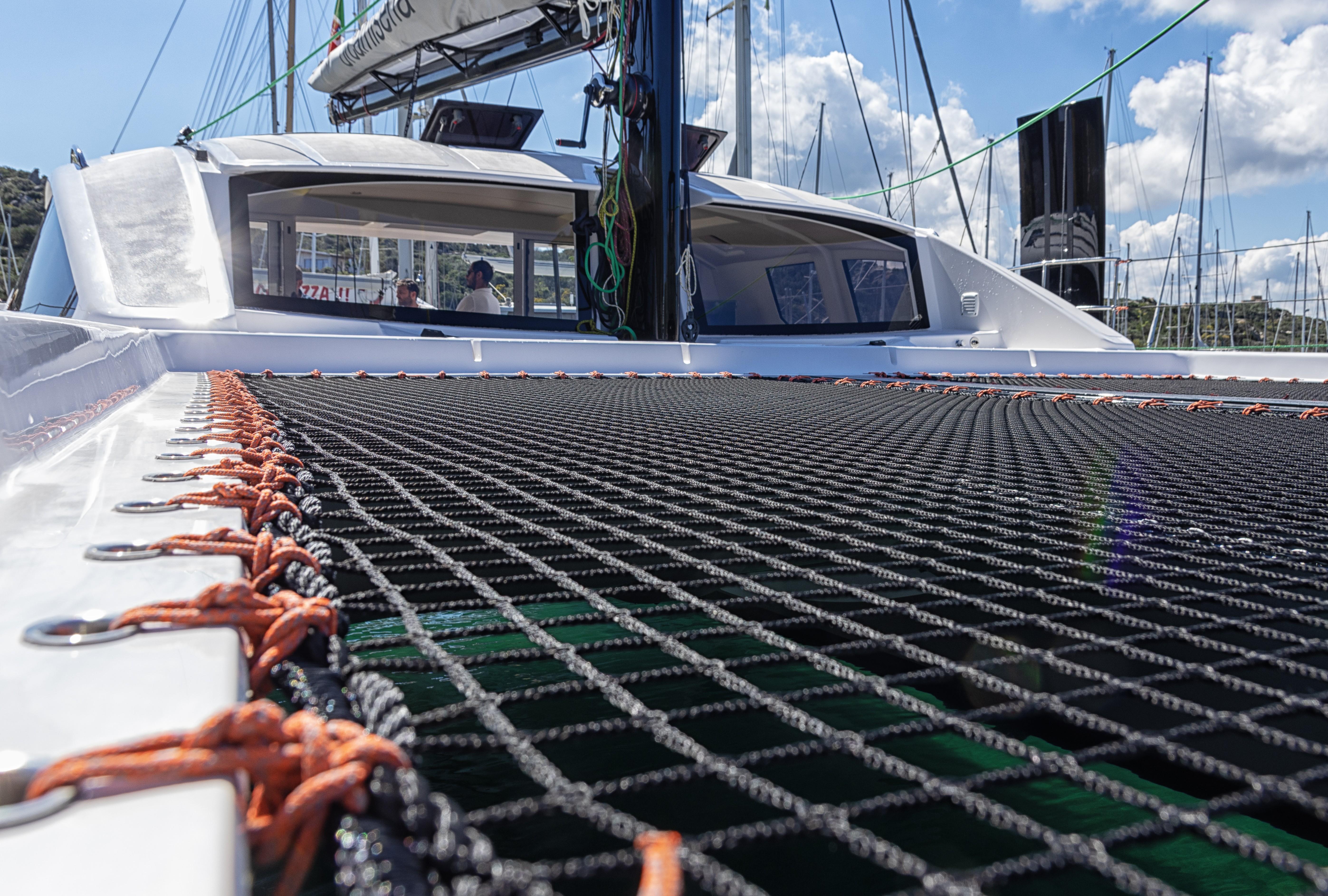 2025 Comar C-Cat 48 catamaran with netting and cabin view under a sunny sky.